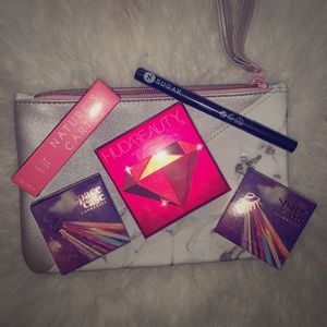 2 highlighters,palette,eyeliner,lipstick,bag